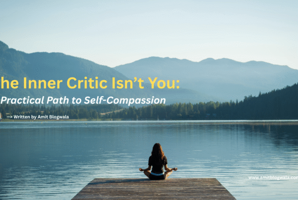 A woman sits cross-legged in meditation on a wooden dock overlooking a calm lake, surrounded by mountains. Text overlay reads: “The Inner Critic Isn’t You: A Practical Path to Self-Compassion – Written by Amit Blogwala.”